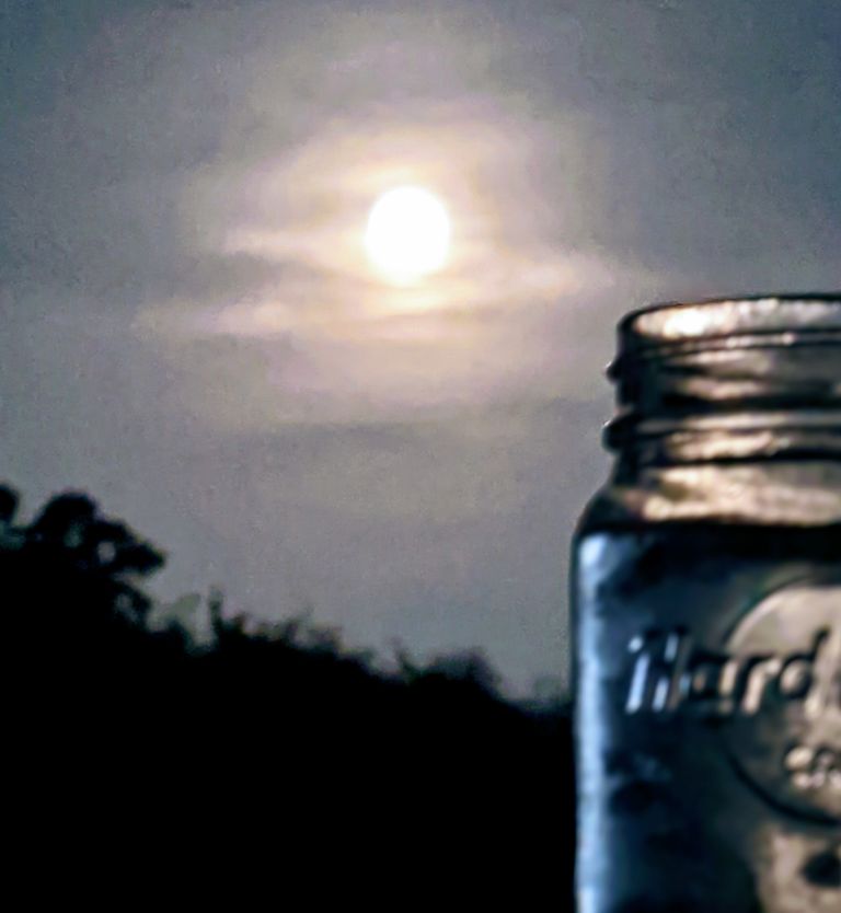 Moon behind jar in foreground