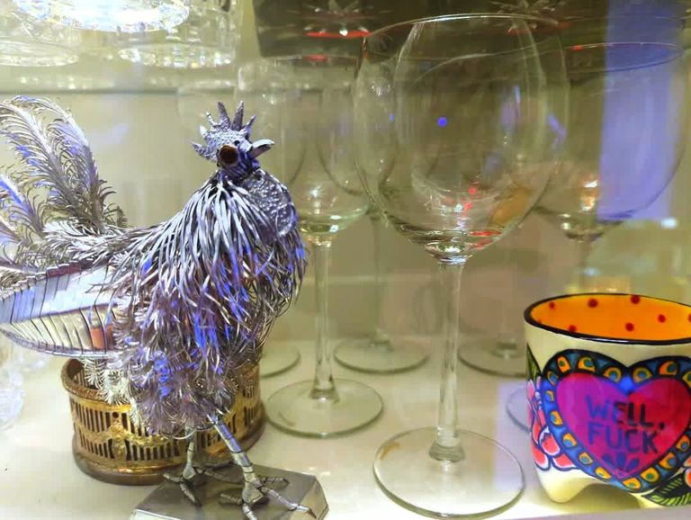 Metal rooster and cup with wine glasses